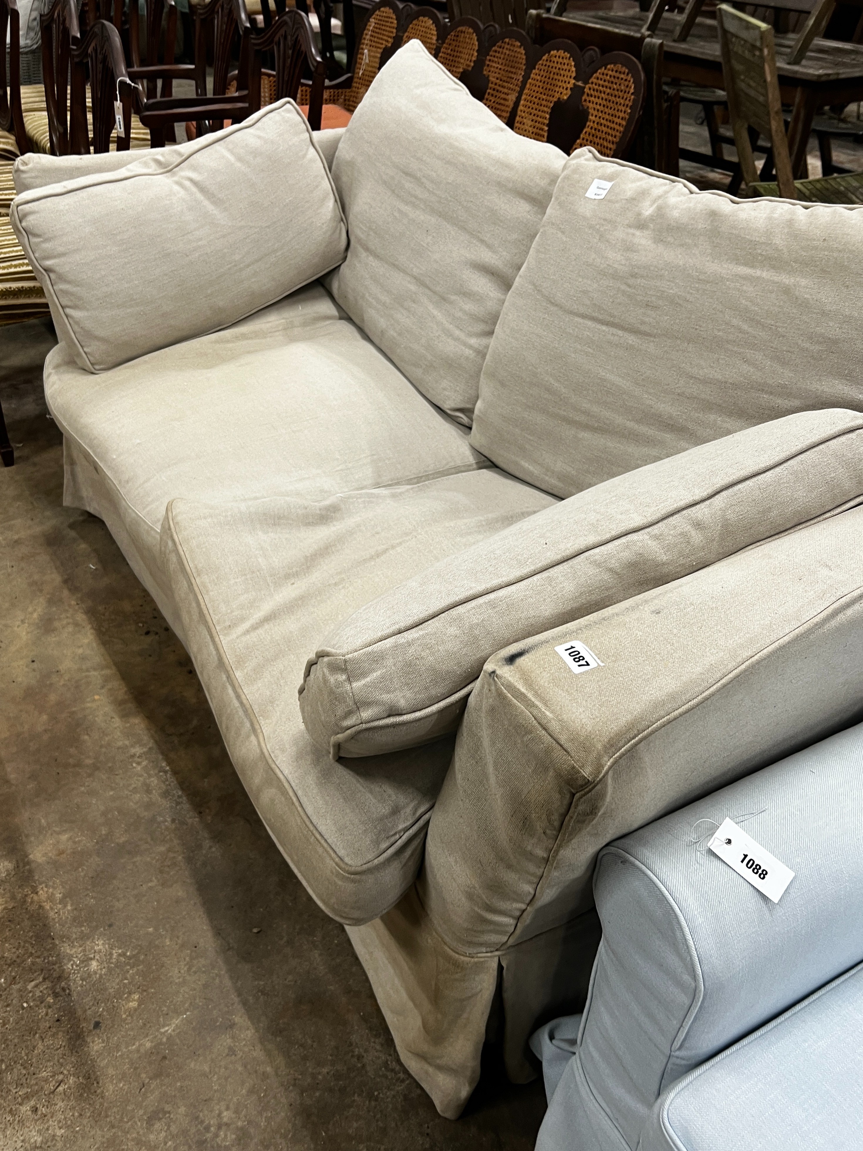 An Oka two seater settee upholstered in a natural linen fabric, length 1080, depth 98cm, height 80cm